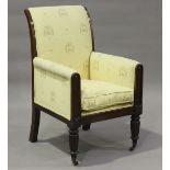 A William IV mahogany framed library armchair, raised on reeded legs and brass castors, height