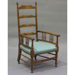 An early 20th century walnut ladder back elbow chair, the seat upholstered in green damask, height