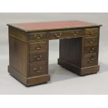 An Edwardian walnut twin-pedestal desk, fitted with an arrangement of nine drawers, height 74cm,