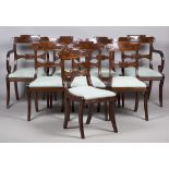 A set of eight Regency figured mahogany bar back dining chairs with carved scroll decoration and