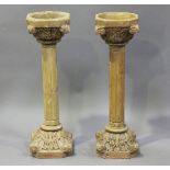 A pair of early 20th century sectional orange-tinted carved stone ornamental pillars with carved