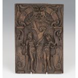 A 17th/18th century carved oak panel, decorated in relief with Adam and Eve below the Tree of