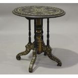 A late 19th century Middle Eastern hardwood and bone inlaid circular wine table, on turned spindle
