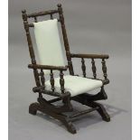 A late 19th century American turned walnut child's rocking armchair, height 73cm, width 40cm.Buyer’s