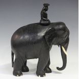 A late 19th/early 20th century Indian carved ebony model of an elephant and rider, height 40cm,