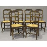 A set of six 20th century French oak framed carved ladder back dining chairs with inset rush