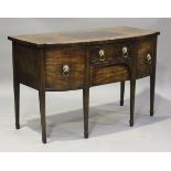 A George III mahogany break bowfront sideboard, fitted with four oak-lined drawers with applied