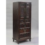 A 19th century Chinese stained softwood side cabinet, the two panelled doors carved with flowers