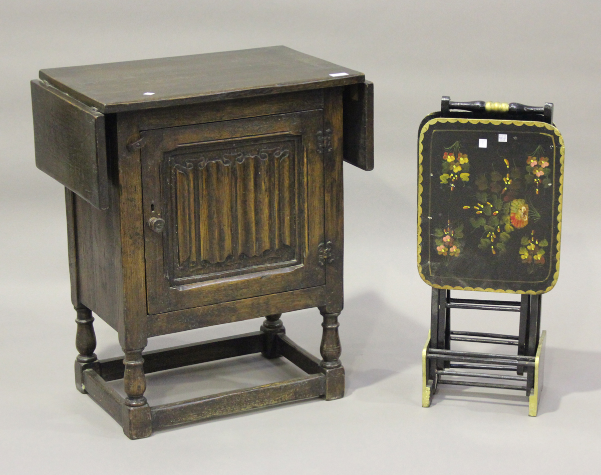 A mid-20th century oak drop-flap side cabinet, the door carved with a linenfold panel, height