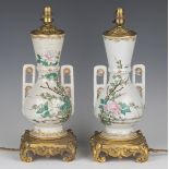 A pair of late 19th century Japanese export porcelain and ormolu mounted table lamps, the twin-