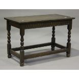 A 17th century style oak centre table, the rectangular top carved with lunettes, height 76cm, length