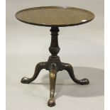 A George III mahogany wine table, the dished top on a turned and carved stem, raised on tripod legs,