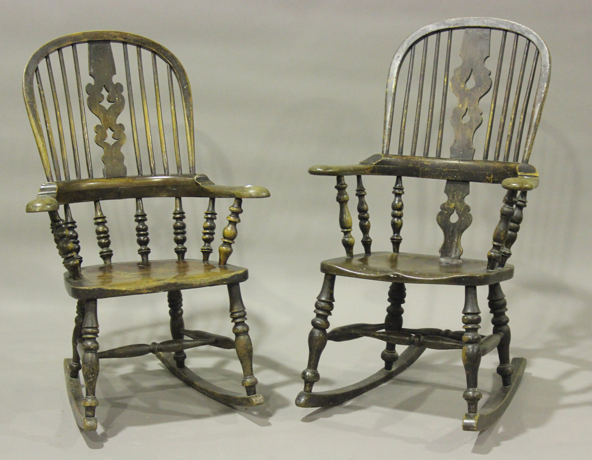 A near pair of Victorian ash and elm pierced splat back Windsor rocking armchairs with shaped hand