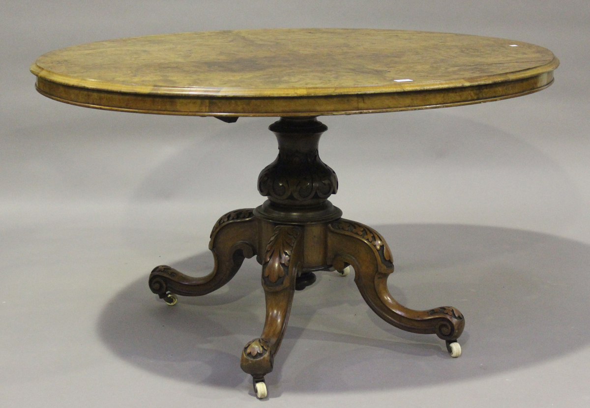 A late Victorian burr walnut oval tip-top breakfast table, raised on carved cabriole legs, height