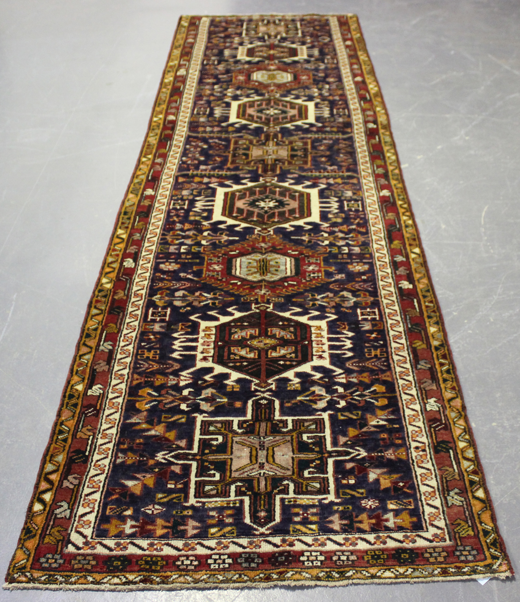 A Heriz runner, North-west Persia, mid-20th century, the midnight blue field with a column of nine