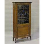 An Edwardian Art Nouveau mahogany display cabinet with overall chequer stringing, the stained and