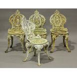 A set of four Victorian white painted cast iron garden chairs with pierced foliate backs, height