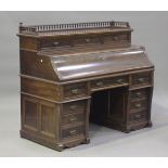 A late Victorian mahogany twin-pedestal writing desk, the gallery fitted with three drawers above