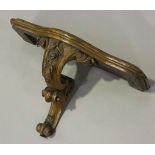 A late Victorian oak wall bracket, the double 'C' scroll support carved with flowers, height 35cm,