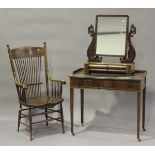 An early Victorian mahogany swing framed mirror with carved sea serpent supports above two cushion