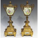 A pair of late 19th century gilt spelter and porcelain mounted ornamental urns, the ovoid bodies