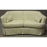 A pair of modern tub back settees, upholstered in plain cream fabric, height 80cm, width 183cm,