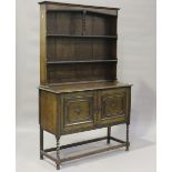 A George V oak dresser with applied geometric mouldings, height 195cm, width 119cm, depth 46cm.