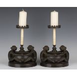 A pair of 20th century South-east Asian brown patinated cast bronze pricket candlesticks, each