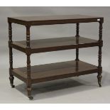 A mid-Victorian mahogany three-tier buffet, on turned baluster legs and castors, height 97cm,