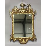 A late 19th century George III style mahogany and gilt painted fretwork wall mirror, the bevelled