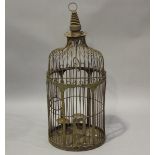 An Indian wrought iron circular bird cage of domed form, fitted with three perches and two