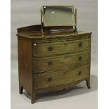 An early 20th century mahogany and crossbanded bowfront chest, fitted with a brushing slide,