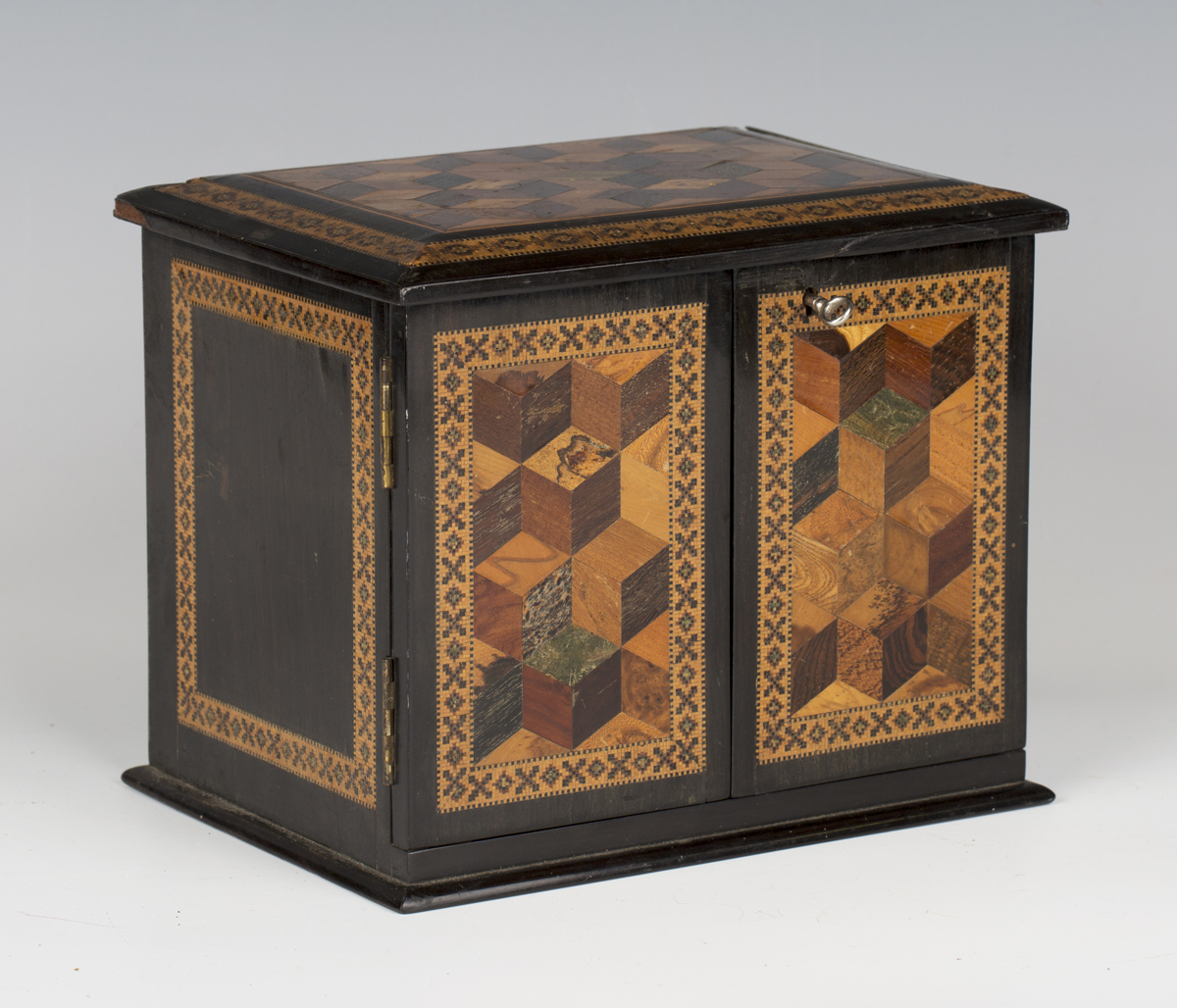 A Victorian Tunbridge ware table-top needlework cabinet, the top and two doors with specimen wood