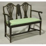 A late 19th century George III style mahogany two-seat settee with scroll arms and arched double