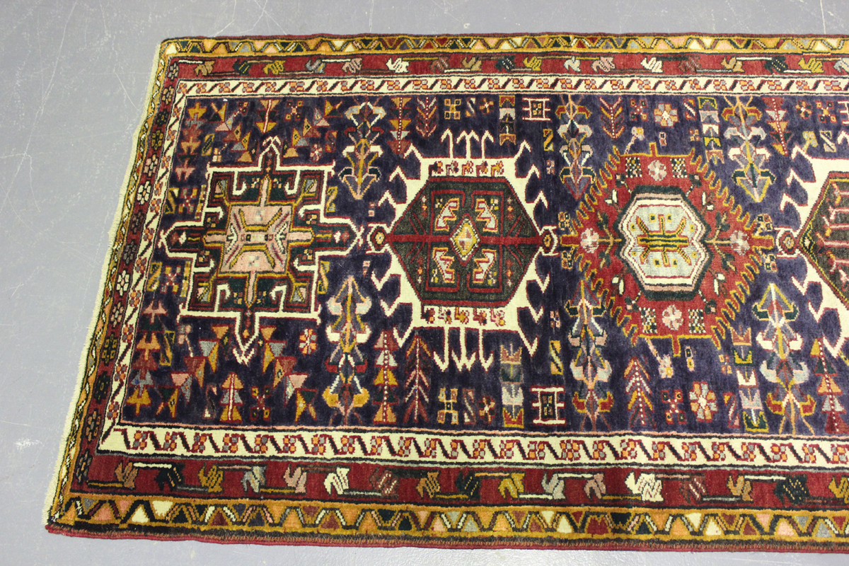 A Heriz runner, North-west Persia, mid-20th century, the midnight blue field with a column of nine - Image 4 of 5