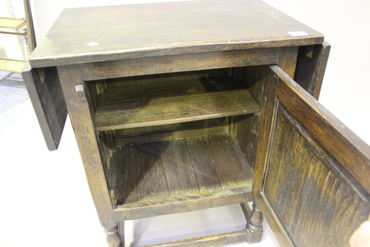 A mid-20th century oak drop-flap side cabinet, the door carved with a linenfold panel, height - Image 5 of 6