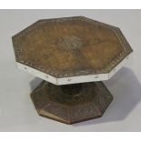 A late 19th century teak octagonal revolving table-top platter, the top carved with a crest and