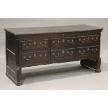 A George III Lancastrian oak mule chest, the hinged lid above six dummy drawers, on block
