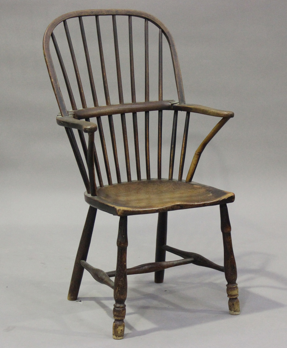 A mid-19th century primitive ash, beech and elm Windsor armchair, the armrests on shaped supports,