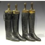 Two pairs of black leather riding boots, both pairs fitted with wooden lasts.Buyer’s Premium 29.