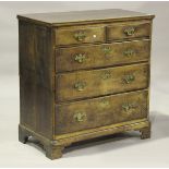 A George III provincial oak chest of two short and three long drawers, on bracket feet, height