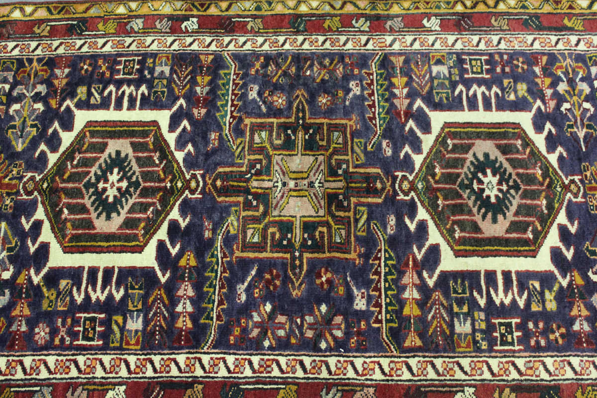 A Heriz runner, North-west Persia, mid-20th century, the midnight blue field with a column of nine - Image 3 of 5