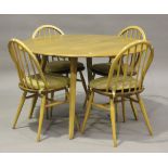 An Ercol elm drop-flap circular dining table, height 71.5cm, diameter 113cm, together with a set