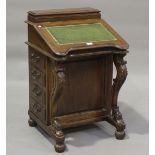 A 20th century Victorian style hardwood Davenport, one side fitted with four drawers, height 86cm,