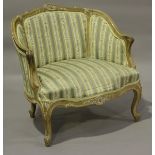 An early 20th century French Rococo Revival limed walnut showframe armchair, height 72cm, width