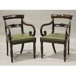 A pair of George IV mahogany bar back elbow chairs with foliate carved centre rails and green