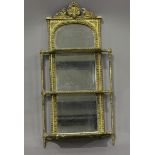 A late Victorian gilt composition three-tier mirror-back wall shelf with scallop shell crest, 87cm x