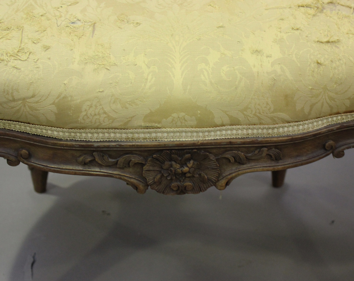 A late 19th century French Louis XV style walnut showframe salon suite, comprising a settee, - Image 5 of 12