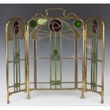 An early 20th century Arts and Crafts brass framed leaded and stained glass triptych firescreen,