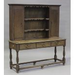 A 20th century reproduction oak dresser, the shelf back above drawers, on turned legs, height 164cm,